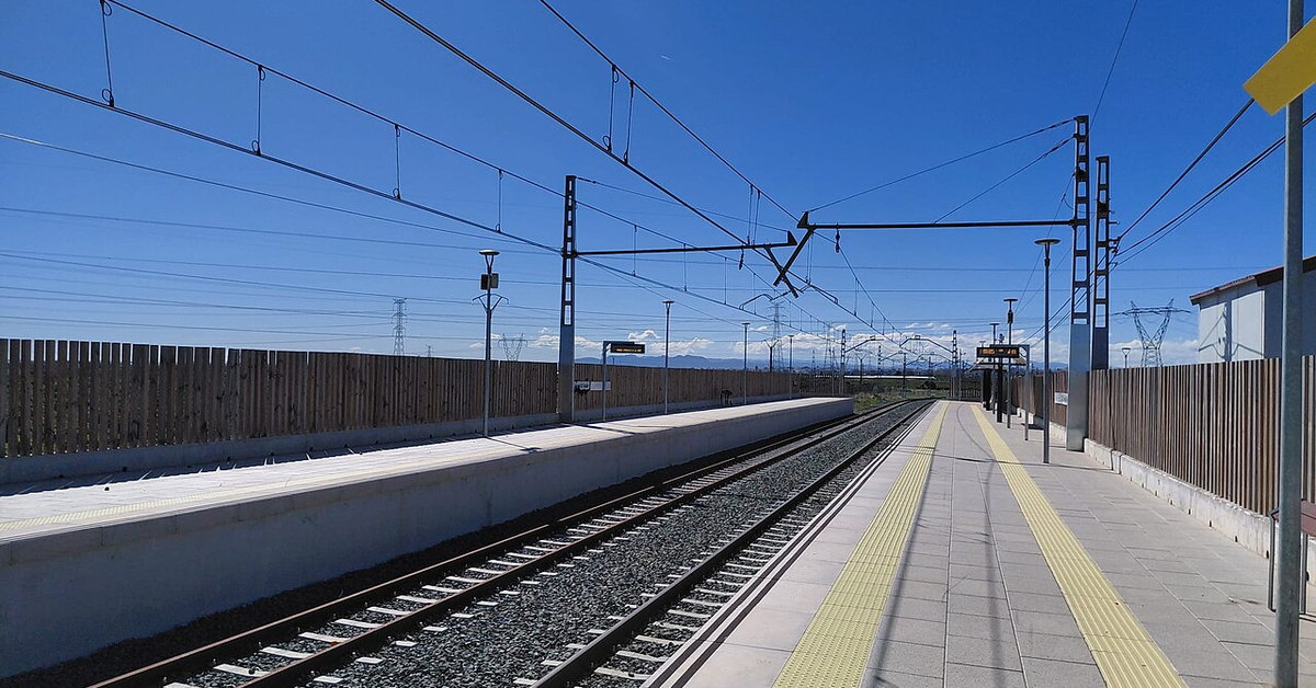 Andén y vías del apeadero de Col·legi El Vedat bajo un cielo despejado